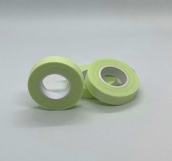 Applying Bout Money Green Lash Tape under the eye during lash extension session