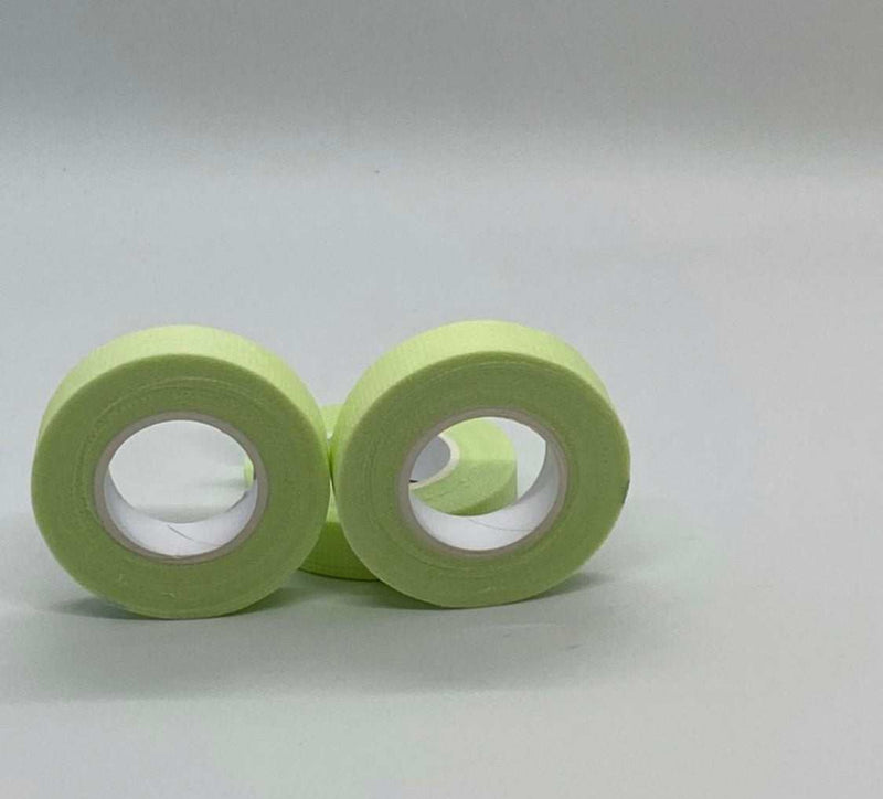 Applying Bout Money Green Lash Tape under the eye during lash extension session